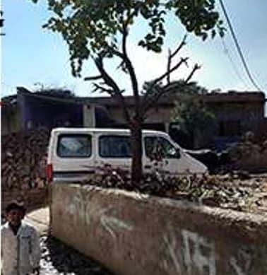 An open roadside drain in front of homes in Jahanpur